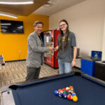 Chase Culligan, GBC student, receives $5 from provost, Joel Worden, for registering for classes and then beating Dr. Worden at a game of pool.