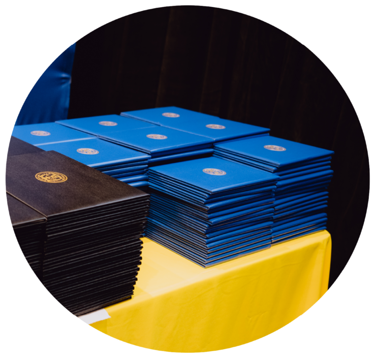 Stacks of academic degrees in folders.