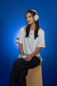 Female Esports team member posing with a control on her hands looking happy