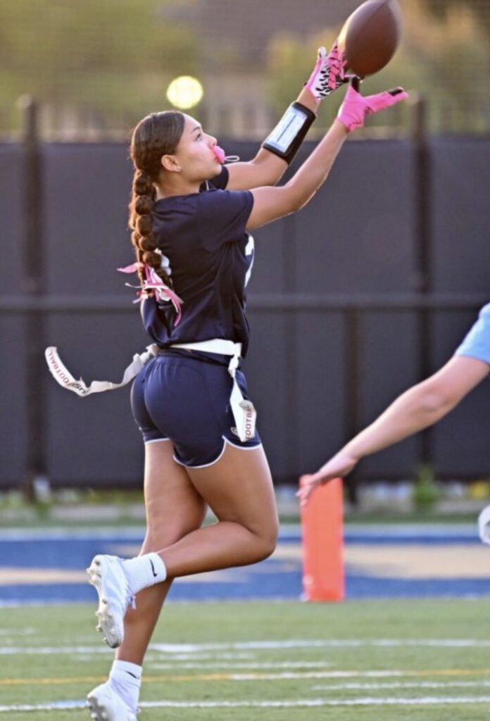 GBC Flag Football player jumping to catch football.