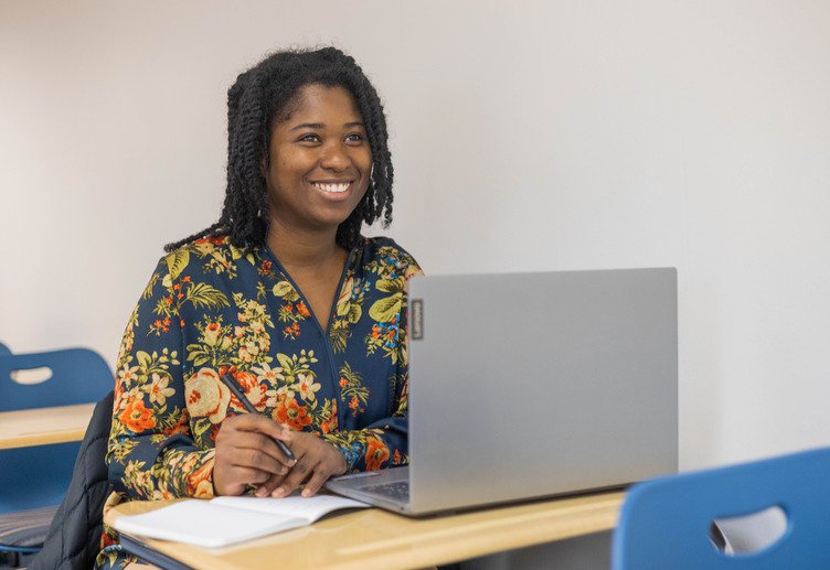 professional working on computer with cybersecurity mba degree