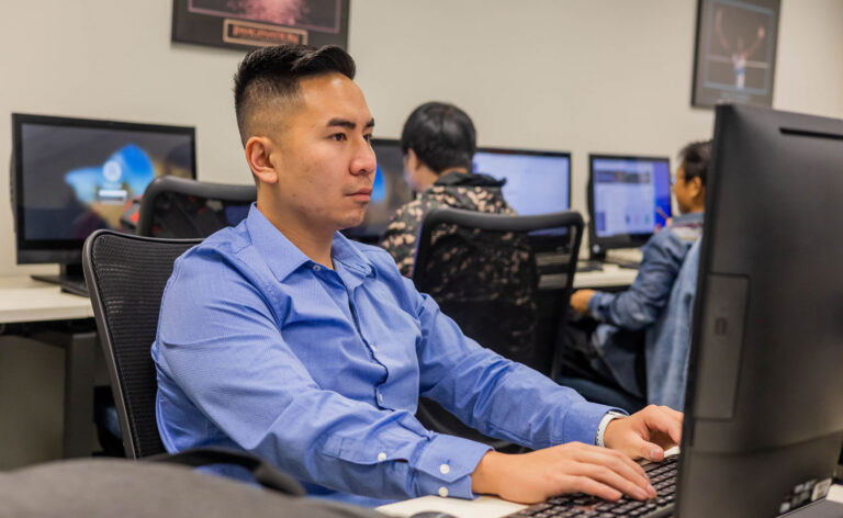 Student working on computer in lab as part of artificial intelligence degree program at GBC