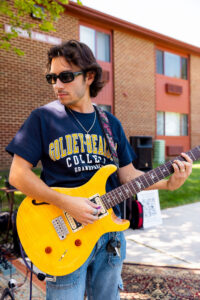 JJ Becerra plays guitar at one of many events that his band, The Suits, performed at for Goldey-Beacom