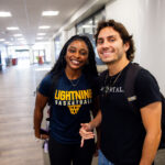 JJ Becerra and another Goldey-Beacom College student post for a photo in the Jones student lounge