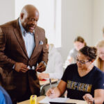 Dr. Scott Glenn talking with a student in a class
