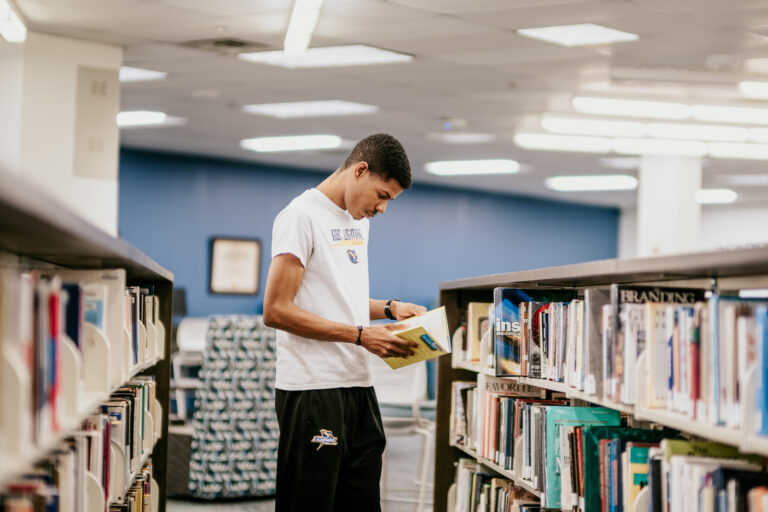 Student reading in library