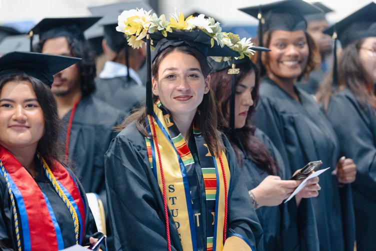 Female students graduating from an accelerated master's program.